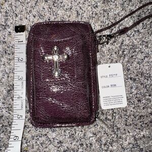 Chic Brown with a tinge of a purple hue Wristlet with Silver Cross Detail